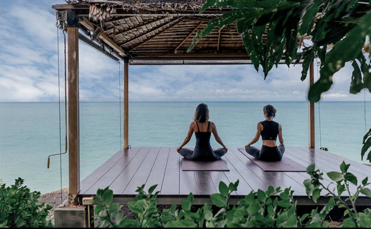 Seaside yoga and meditation retreat overlooking the Gulf of Thailand, low-density wellness living.